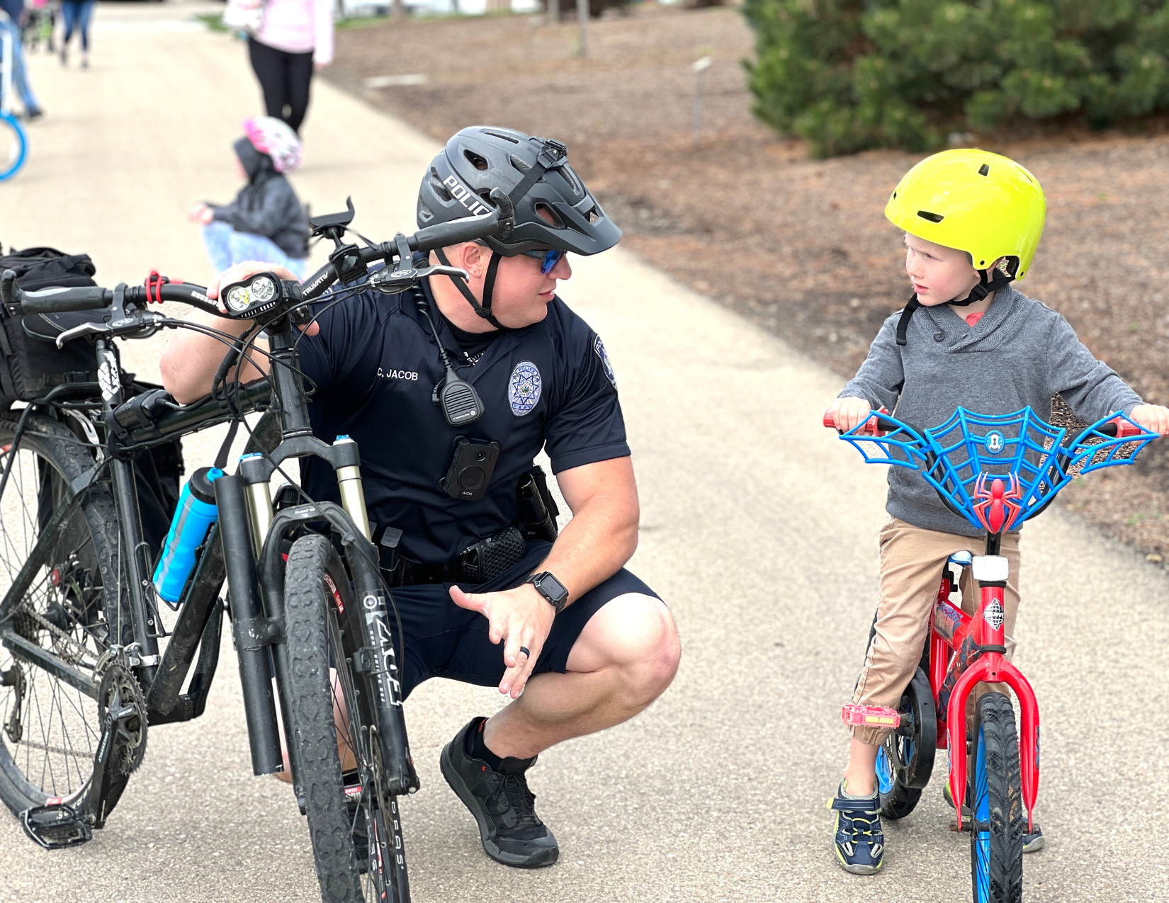 Meridian Police Officer teaching youth bicycle riding skills